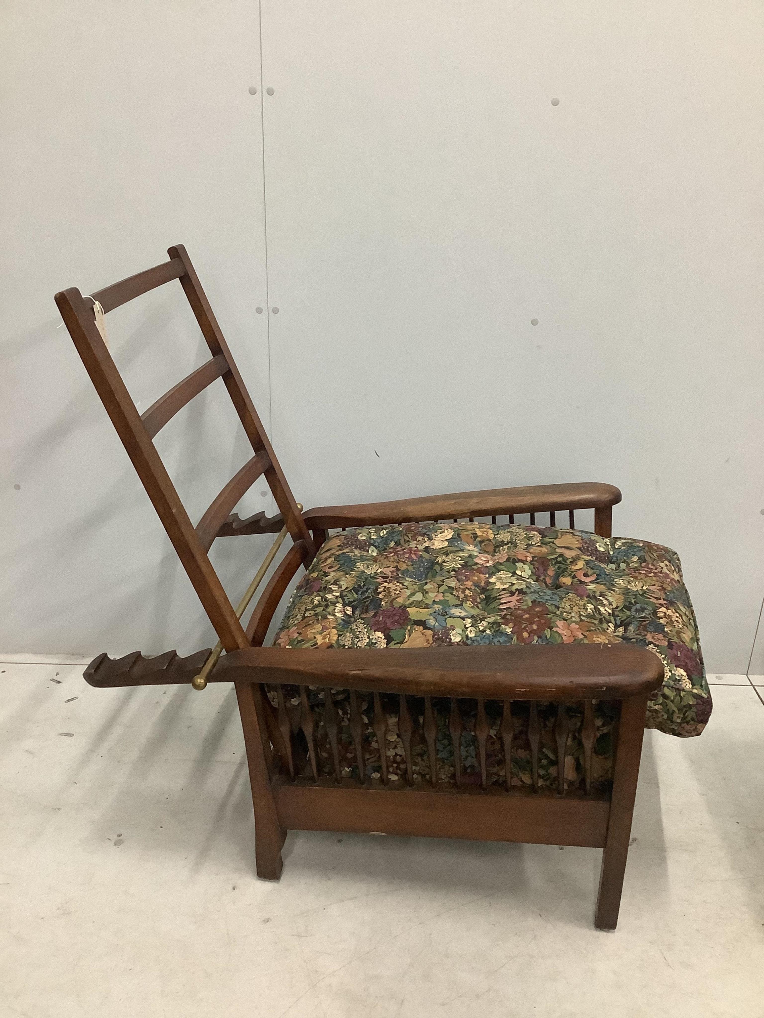 An early 20th century Morris style beech reclining armchair with a matching footstool, width 78cm, depth 92cm, height 108cm. Condition - fair